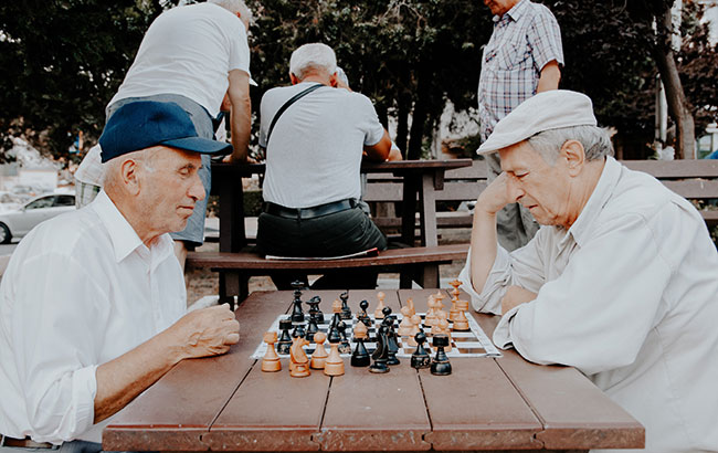 Men playing chess at a park