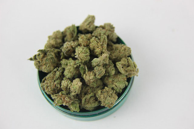 A bowl of dried cannabis buds as viewed from above