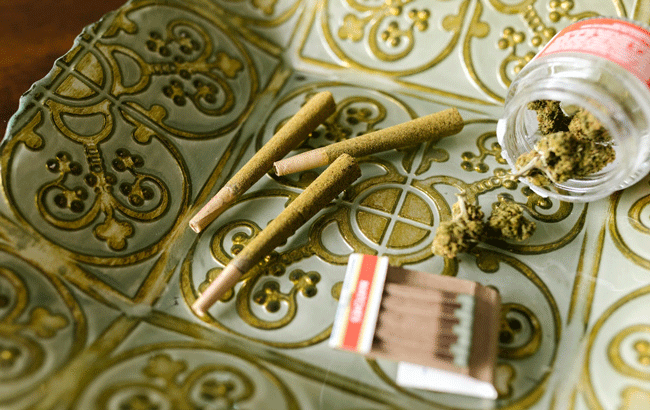 cannabis flower next to joints