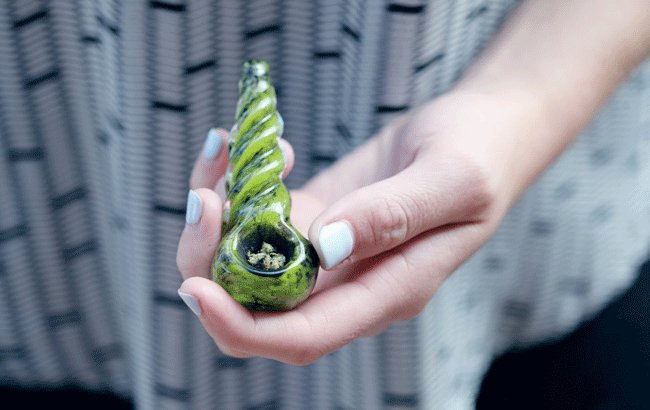 green pipe filled with cannabis