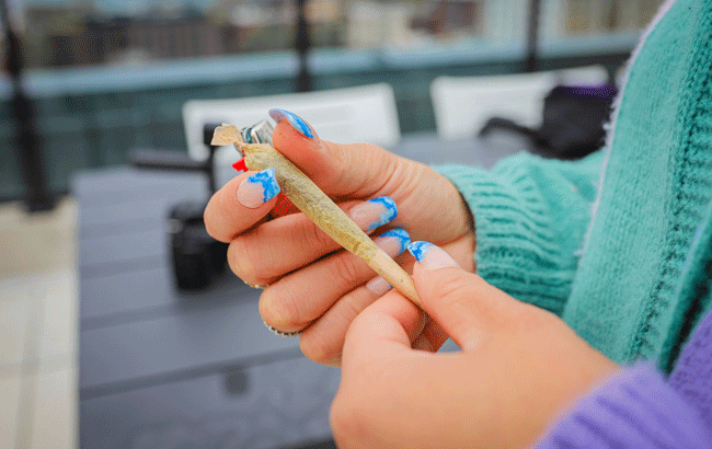 person rolling a joint