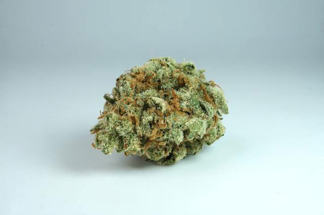 Dried cannabis on a white surface