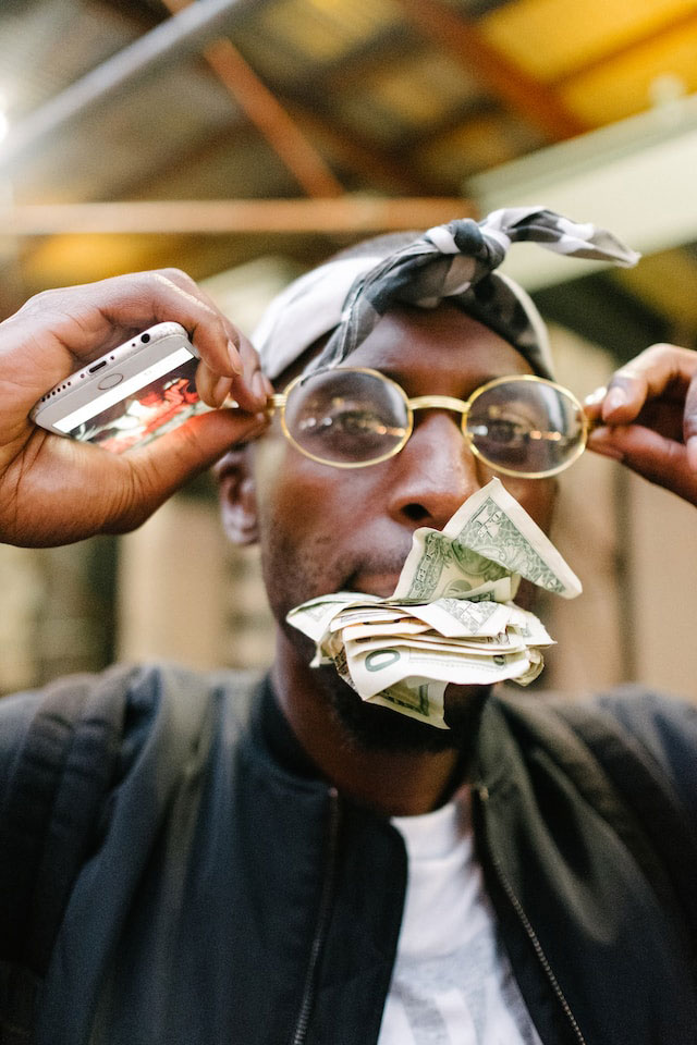 A person with cash in their mouth.
