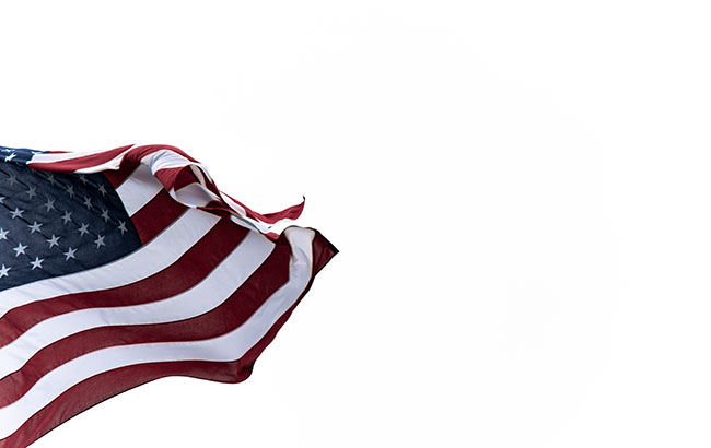 American flag waving against a white background