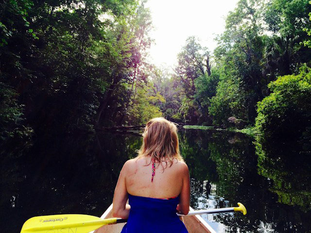 A person kayaking on a river in Wekiwa Springs, FL.