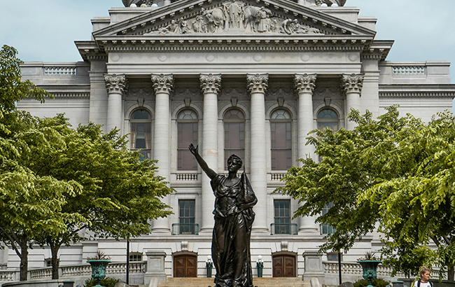 A statue in front of the capitol building in Madison